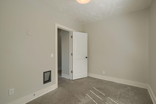 909-915 Wilson Ave, Columbus, OH 43206 - unfurnished room featuring carpet, baseboards, and a textured ceiling