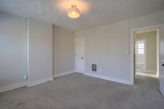909-915 Wilson Ave, Columbus, OH 43206 - spare room featuring carpet, a textured ceiling, and baseboards