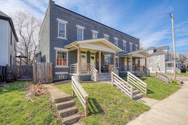 909-915 Wilson Ave, Columbus, OH 43206 - view of property featuring covered porch and brick siding