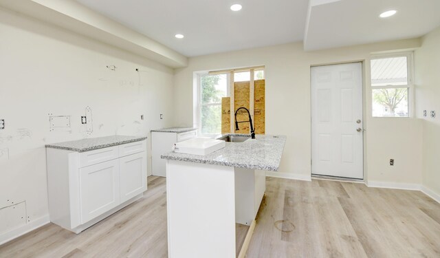 1292-1298 E 17th Ave, Columbus, OH 43211 - kitchen featuring a sink, light stone countertops, light wood-style floors, white cabinets, and recessed lighting