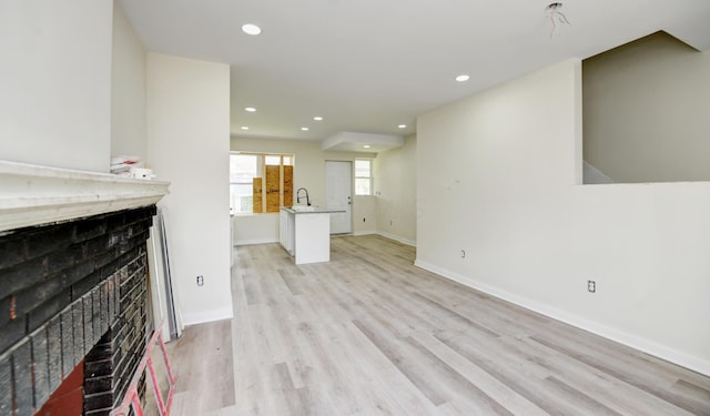 1292-1298 E 17th Ave, Columbus, OH 43211 - unfurnished living room with a fireplace, recessed lighting, light wood-style flooring, and baseboards