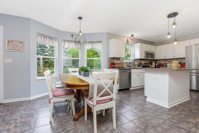 302 Streamwater Ct, Blacklick, OH 43004 - kitchen with appliances with stainless steel finishes, decorative backsplash, white cabinetry, pendant lighting, and baseboards