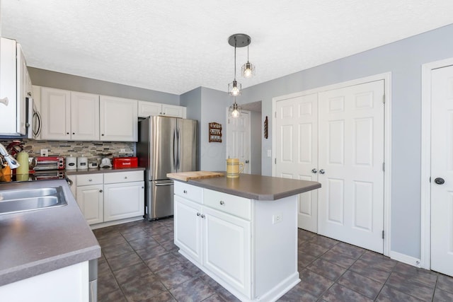 302 Streamwater Ct, Blacklick, OH 43004 - kitchen with stainless steel appliances, a sink, white cabinetry, a kitchen island, and hanging light fixtures