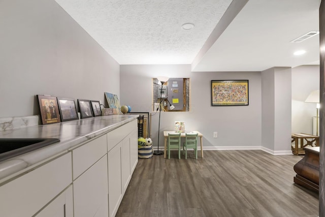 302 Streamwater Ct, Blacklick, OH 43004 - bar area with dark wood-type flooring, baseboards, and a textured ceiling