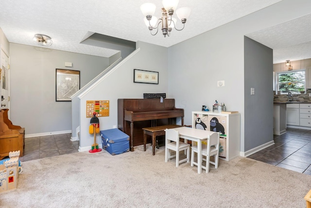 302 Streamwater Ct, Blacklick, OH 43004 - sitting room featuring carpet, a chandelier, a textured ceiling, and tile patterned floors