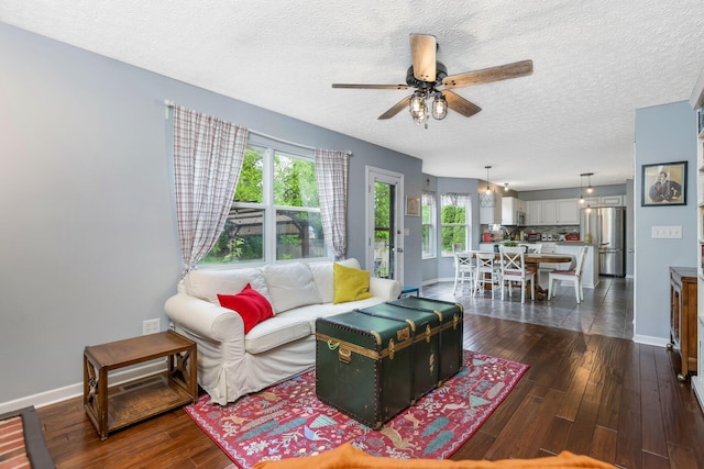 302 Streamwater Ct, Blacklick, OH 43004 - living room with a textured ceiling, ceiling fan, dark wood-style flooring, and baseboards