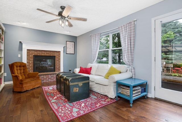 302 Streamwater Ct, Blacklick, OH 43004 - living area featuring a fireplace, wood-type flooring, a textured ceiling, and a ceiling fan