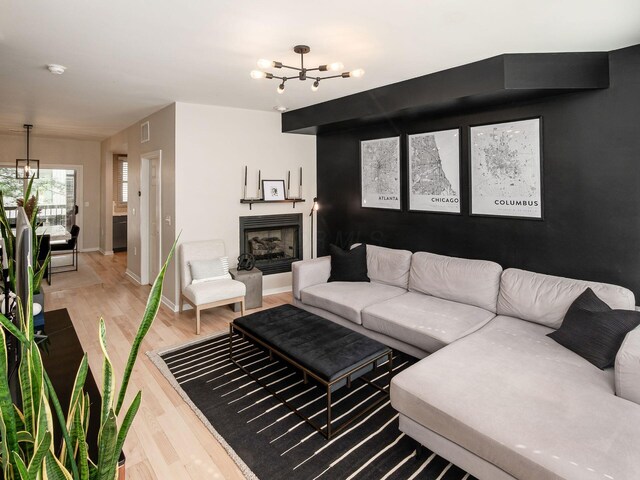 802 N 4th St Unit 802, Columbus, OH 43215 - living area featuring a chandelier, light wood finished floors, baseboards, and a fireplace