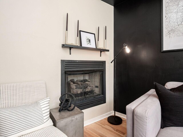 802 N 4th St Unit 802, Columbus, OH 43215 - sitting room with wood finished floors, a fireplace, and baseboards