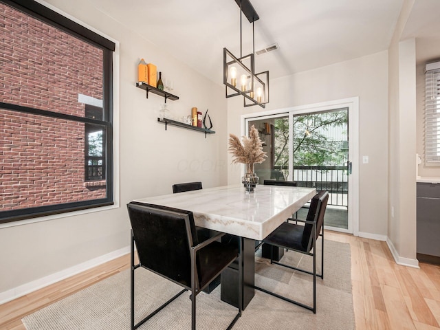 802 N 4th St Unit 802, Columbus, OH 43215 - dining room featuring light wood finished floors, baseboards, and a chandelier