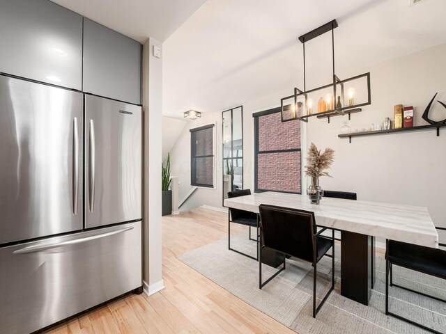 802 N 4th St Unit 802, Columbus, OH 43215 - dining area featuring light wood finished floors, a chandelier, and baseboards