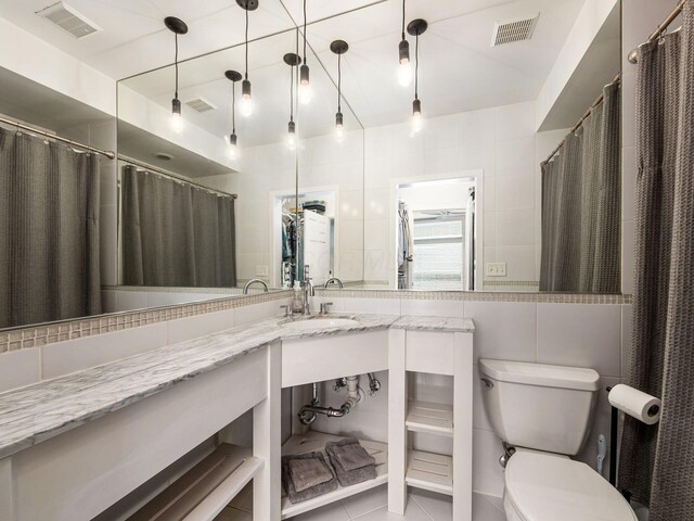 802 N 4th St Unit 802, Columbus, OH 43215 - bathroom with toilet, tile walls, and vanity