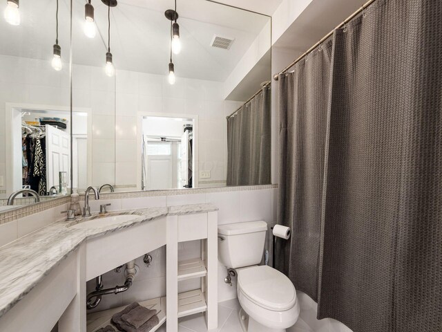 802 N 4th St Unit 802, Columbus, OH 43215 - full bathroom with tile walls, toilet, vanity, and tile patterned floors