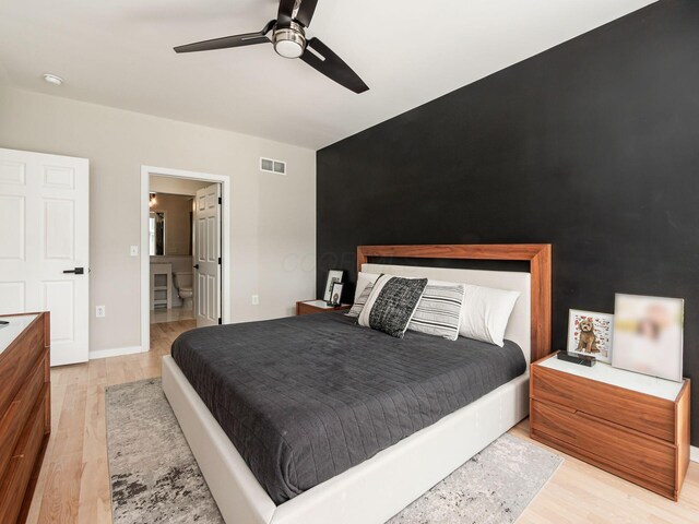 802 N 4th St Unit 802, Columbus, OH 43215 - bedroom with light wood-type flooring, a ceiling fan, and connected bathroom