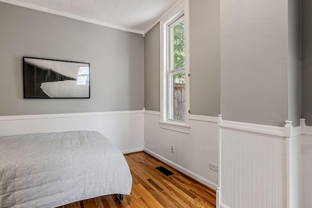 646 S Pearl St, Columbus, OH 43206 - bedroom with wood finished floors, wainscoting, and crown molding