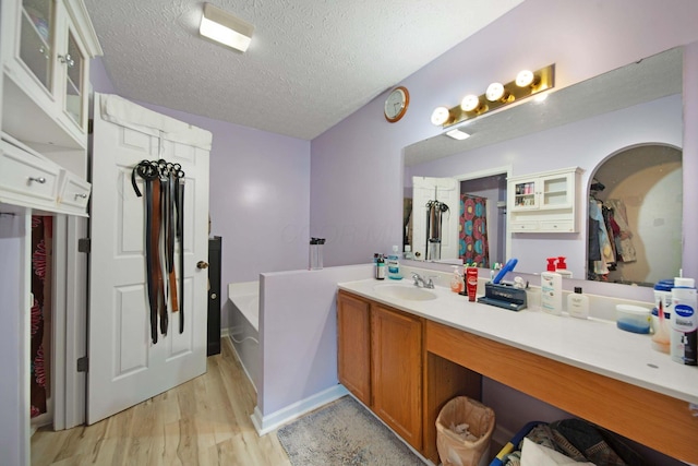 7619 Rippingale St, Blacklick, OH 43004 - full bath with a bath, vanity, wood finished floors, and a textured ceiling