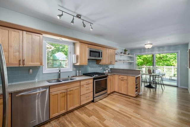 8121 Blind Brook Ct, Columbus, OH 43235 - kitchen featuring stainless steel appliances, open shelves, a peninsula, light wood-style floors, and backsplash