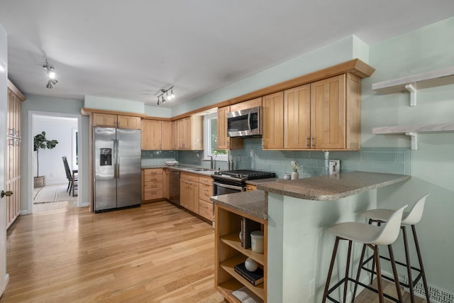 8121 Blind Brook Ct, Columbus, OH 43235 - kitchen featuring appliances with stainless steel finishes, open shelves, a peninsula, and rail lighting