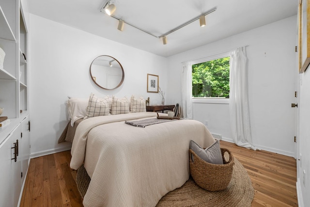 8121 Blind Brook Ct, Columbus, OH 43235 - bedroom with light wood-style flooring and rail lighting