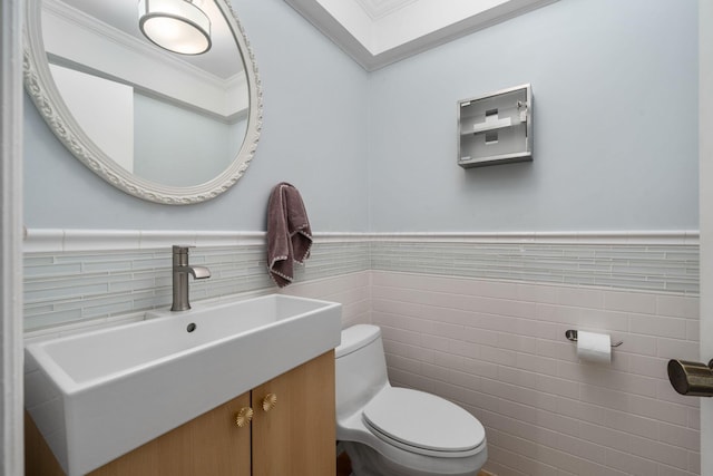 8121 Blind Brook Ct, Columbus, OH 43235 - bathroom featuring tile walls, vanity, ornamental molding, a skylight, and a wainscoted wall