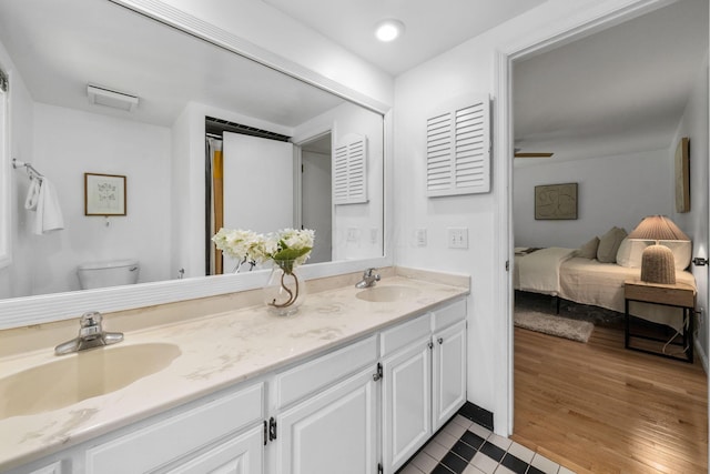8121 Blind Brook Ct, Columbus, OH 43235 - ensuite bathroom featuring double vanity and wood finished floors