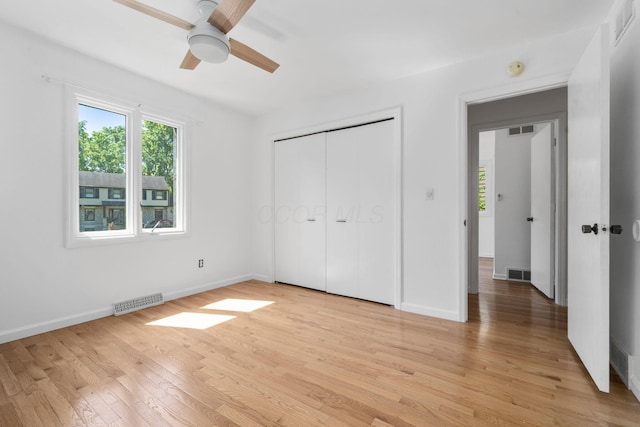 8121 Blind Brook Ct, Columbus, OH 43235 - unfurnished bedroom featuring multiple windows, light wood-type flooring, a closet, and ceiling fan