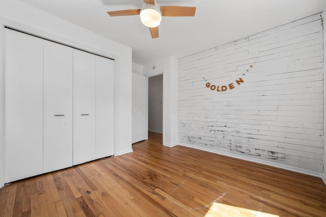 8121 Blind Brook Ct, Columbus, OH 43235 - unfurnished bedroom featuring brick wall, light wood finished floors, a closet, and ceiling fan