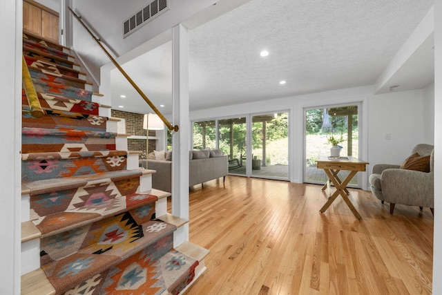 8121 Blind Brook Ct, Columbus, OH 43235 - living room featuring light wood-style floors, a textured ceiling, and recessed lighting