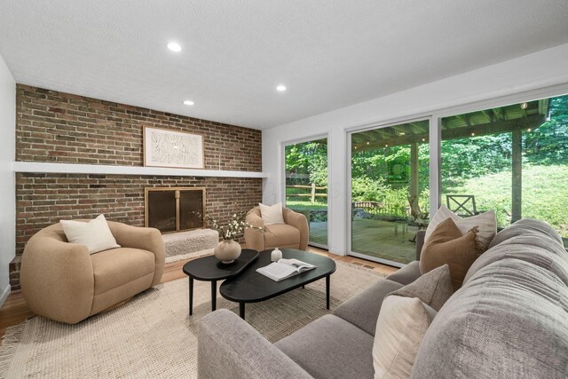 8121 Blind Brook Ct, Columbus, OH 43235 - living area with plenty of natural light, wood finished floors, recessed lighting, brick wall, and a brick fireplace