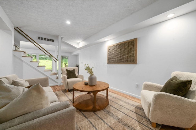 8121 Blind Brook Ct, Columbus, OH 43235 - living area with light wood finished floors, stairs, recessed lighting, and a textured ceiling