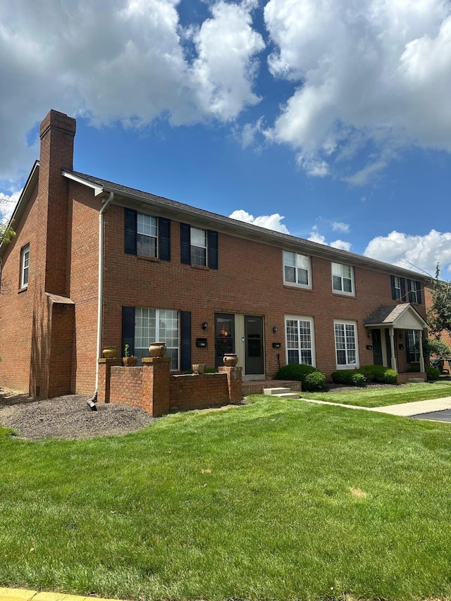 1342-48 Palmer House Ct Unit D, Columbus, OH 43235 - view of front of house with a chimney, a front lawn, and brick siding