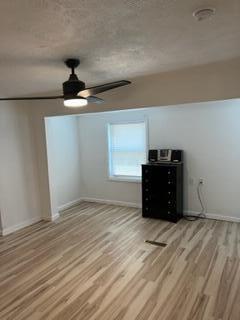 130 N 11th St, Newark, OH 43055 - unfurnished bedroom with wood finished floors, baseboards, and ceiling fan