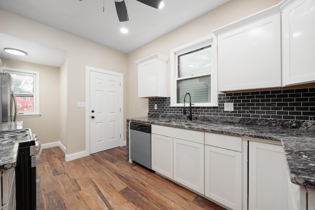 463 E Woodrow Ave, Columbus, OH 43207 - kitchen featuring appliances with stainless steel finishes, a sink, wood finished floors, ceiling fan, and backsplash
