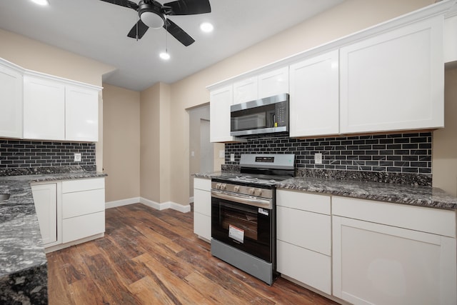 463 E Woodrow Ave, Columbus, OH 43207 - kitchen with appliances with stainless steel finishes, baseboards, dark wood-type flooring, tasteful backsplash, and white cabinetry