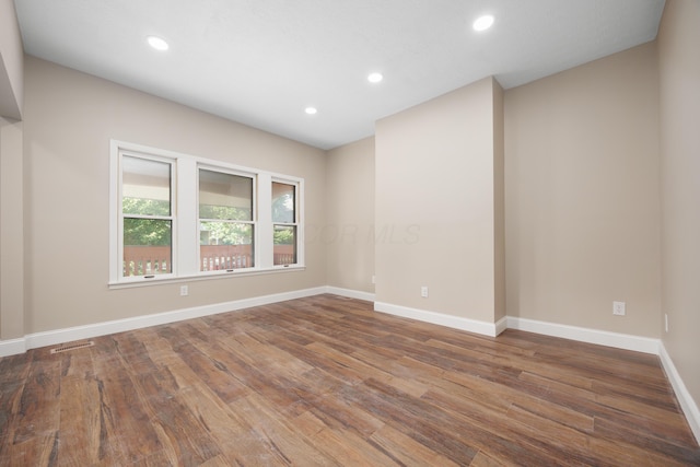 463 E Woodrow Ave, Columbus, OH 43207 - unfurnished room with wood finished floors, baseboards, and recessed lighting