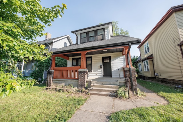 463 E Woodrow Ave, Columbus, OH 43207 - view of front facade featuring covered porch, a front lawn, and a shingled roof