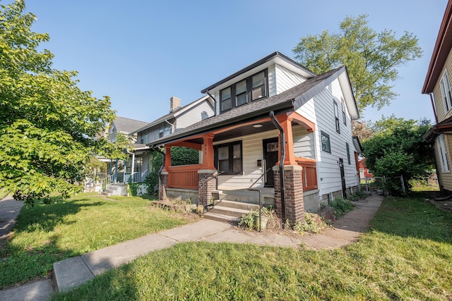 463 E Woodrow Ave, Columbus, OH 43207 - view of front of house with covered porch, a front yard, and a shingled roof