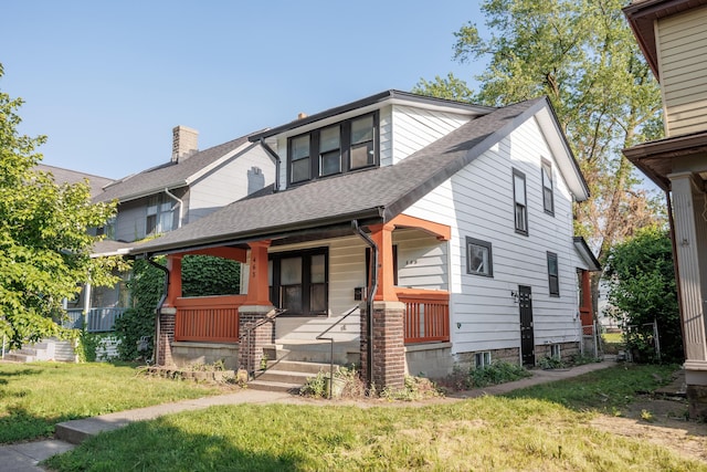 463 E Woodrow Ave, Columbus, OH 43207 - view of front of house with covered porch, a shingled roof, and a front yard