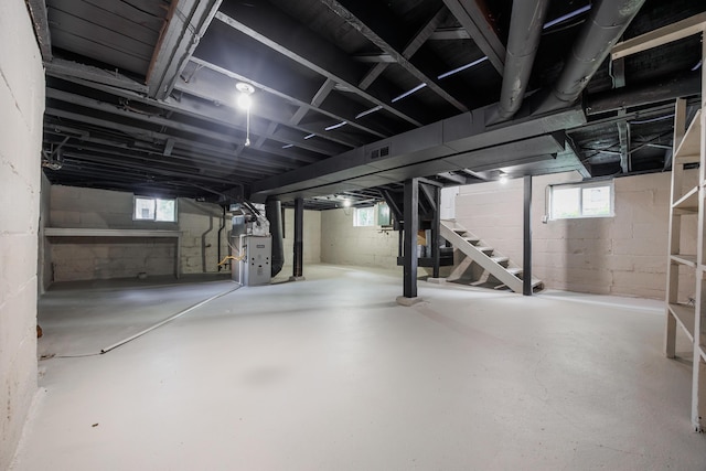 463 E Woodrow Ave, Columbus, OH 43207 - below grade area featuring stairs, heating unit, and plenty of natural light