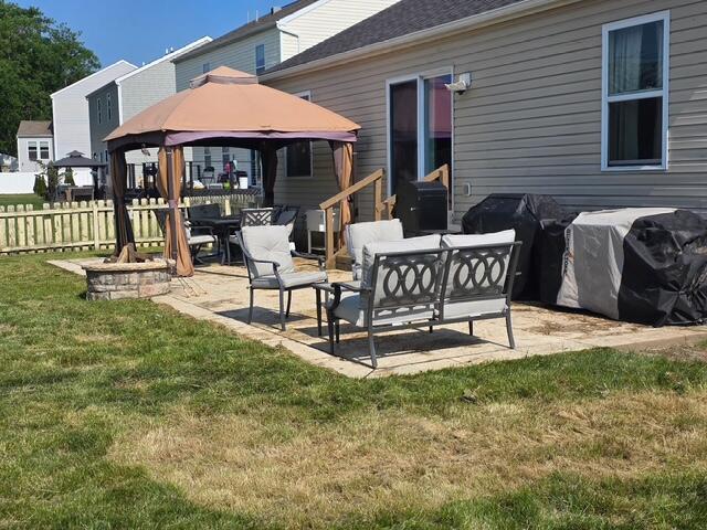 1405 Hoovler Way, Pataskala, OH 43062 - rear view of property featuring a gazebo, a patio area, and an outdoor living space with a fire pit