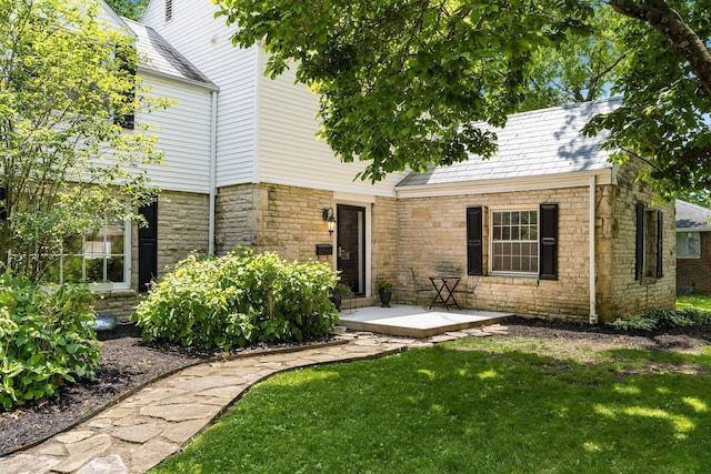 128 S Kellner Rd, Columbus, OH 43209 - rear view of property featuring stone siding and a yard