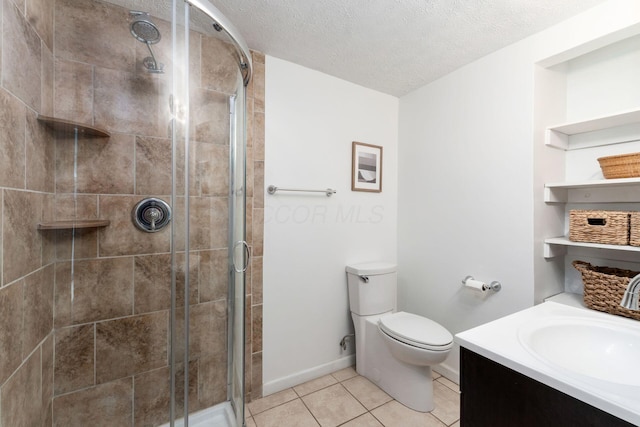 128 S Kellner Rd, Columbus, OH 43209 - bathroom featuring a shower stall, a textured ceiling, toilet, tile patterned flooring, and vanity