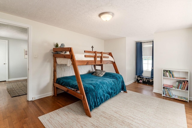 128 S Kellner Rd, Columbus, OH 43209 - bedroom featuring wood finished floors, a textured ceiling, and baseboards
