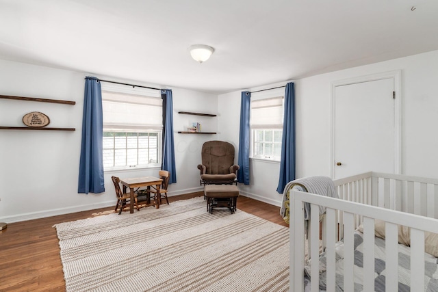 128 S Kellner Rd, Columbus, OH 43209 - bedroom with wood finished floors, multiple windows, and baseboards