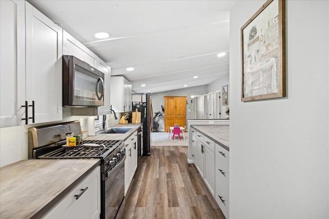 5895 Swartz Mill Rd SE, Sugar Grove, OH 43155 - kitchen with stainless steel appliances, a sink, dark wood-style floors, white cabinetry, and light countertops