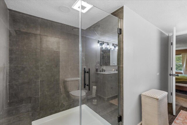 5895 Swartz Mill Rd SE, Sugar Grove, OH 43155 - full bath featuring a stall shower, a textured ceiling, vanity, and toilet