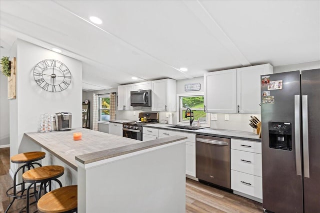 5895 Swartz Mill Rd SE, Sugar Grove, OH 43155 - kitchen with stainless steel appliances, a sink, healthy amount of natural light, light wood-style floors, and recessed lighting