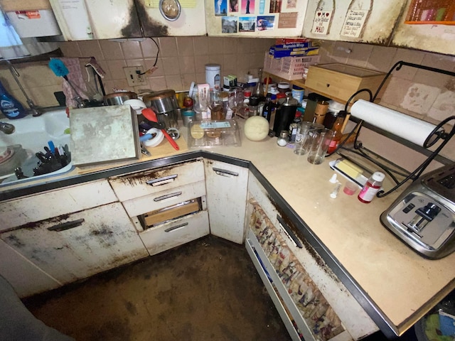 271 S Warren Ave, Columbus, OH 43204 - kitchen with light countertops, decorative backsplash, and concrete flooring