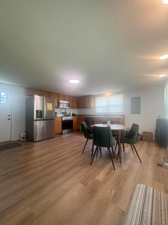 53 State St, Jeffersonville, OH 43128 - dining room featuring a textured ceiling, light wood-type flooring, electric panel, and recessed lighting