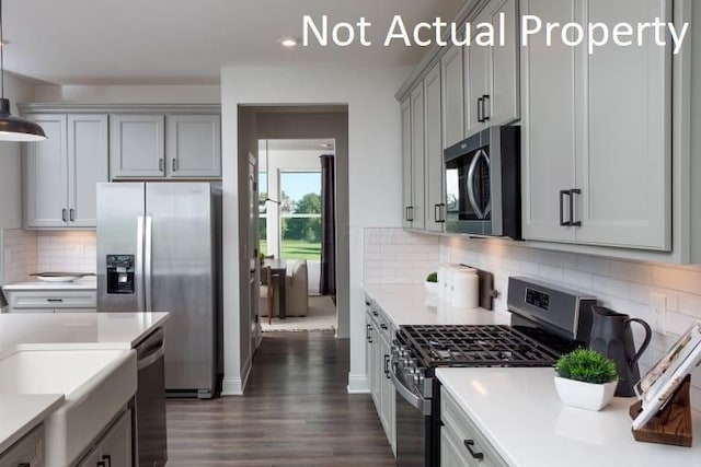 3323 Tender Ave Lot 7165, Powell, OH 43065 - kitchen with appliances with stainless steel finishes, light countertops, dark wood-style floors, decorative backsplash, and recessed lighting